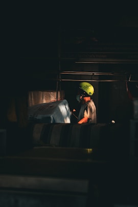 A person wearing a bright green helmet at work.