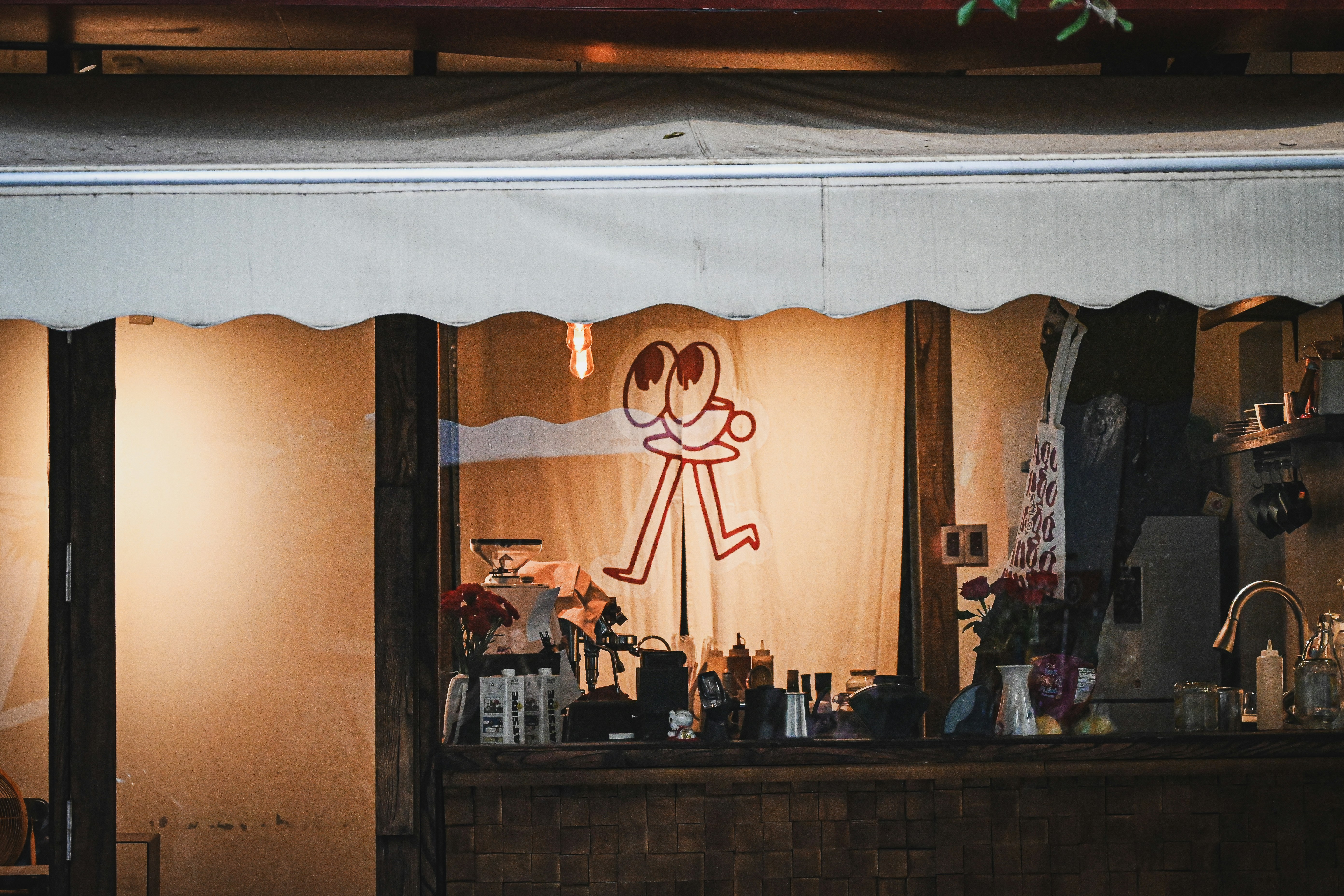 A shopfront features a cute, quirky illustration.