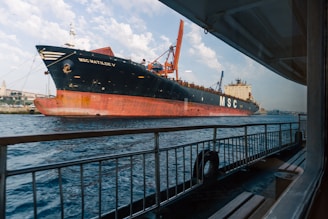 A large cargo ship cruises on the ocean.