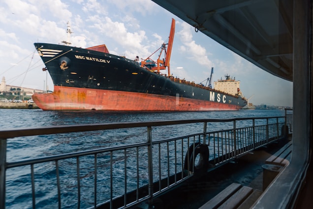 A large cargo ship cruises on the ocean.