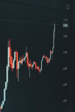 Stock market graph shows fluctuating trends.