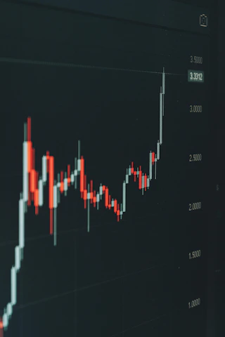 Stock market graph shows fluctuating trends.