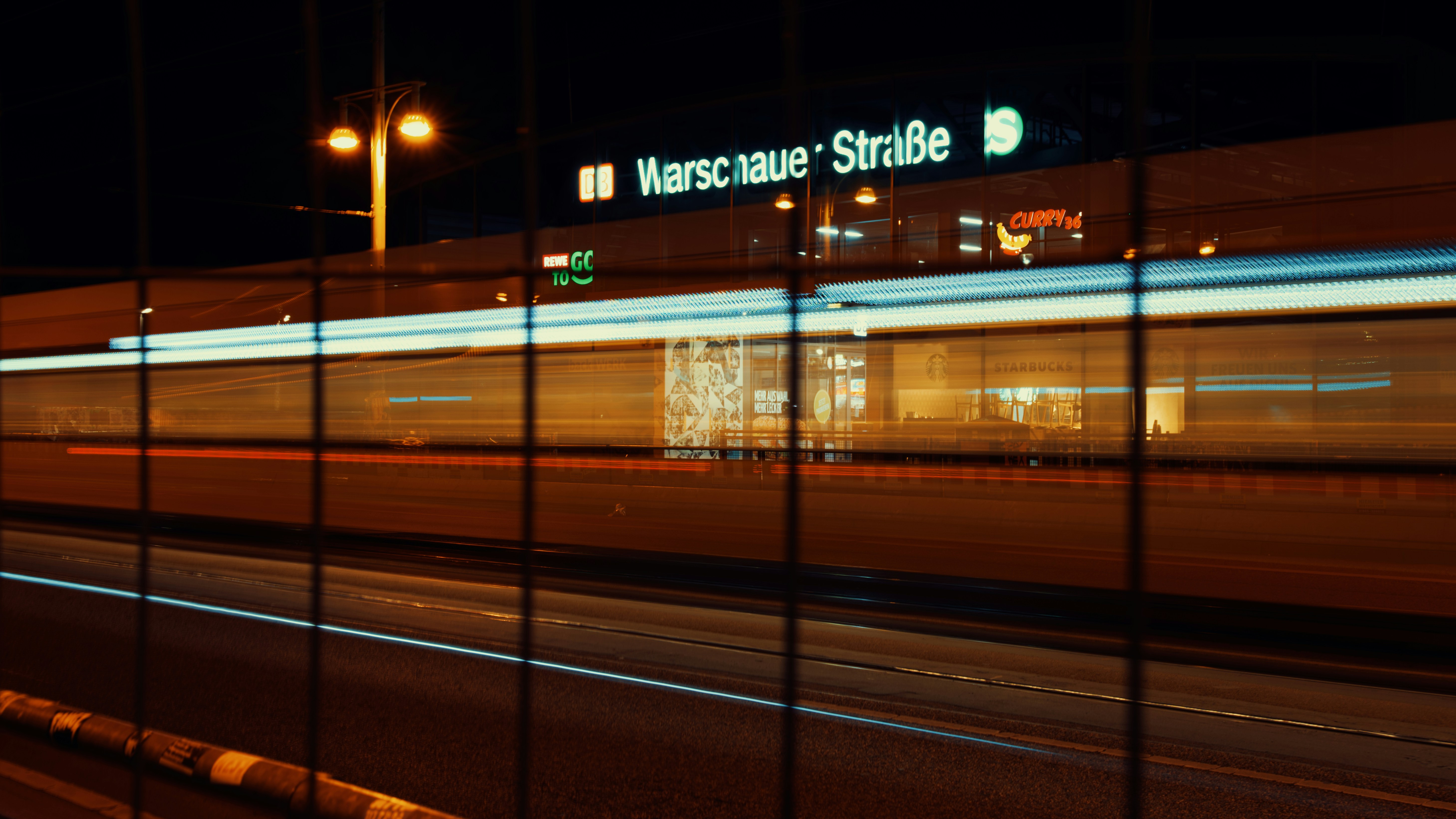 A night photo of a street in warsaw.