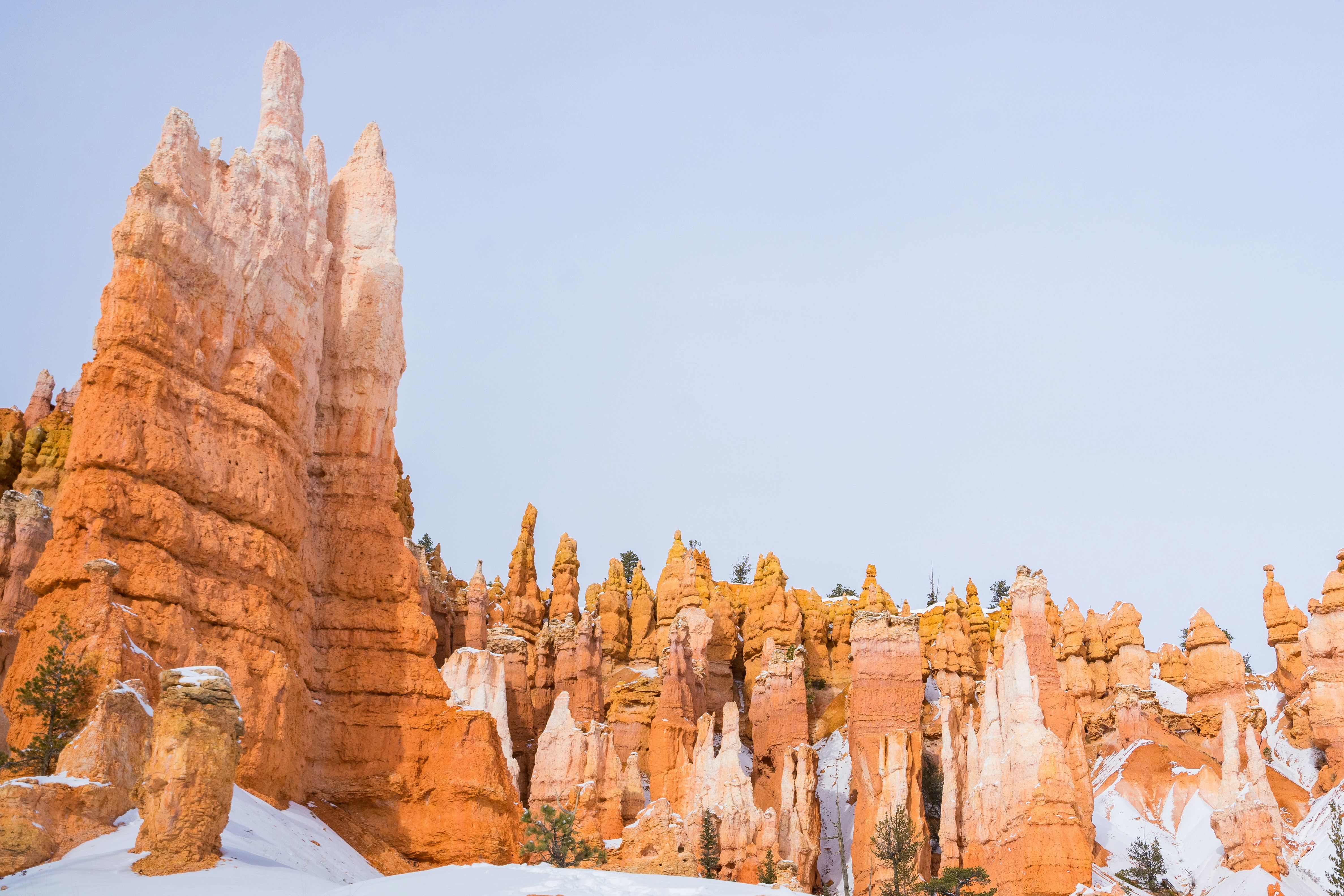 Hoodoos stand tall in a winter landscape.