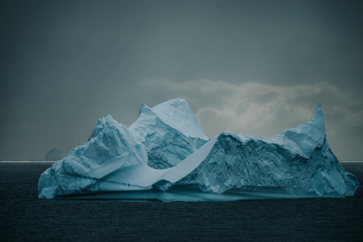 A large iceberg floating on calm Antarctic water