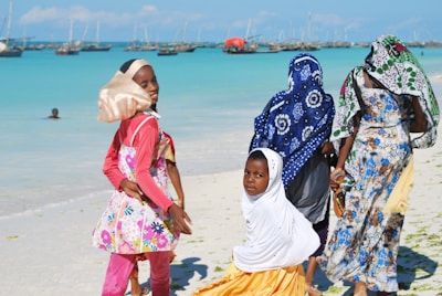 People are enjoying the beach in colorful outfits.