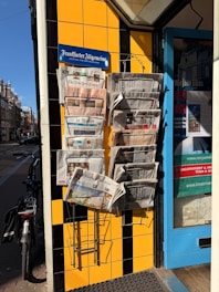 Newspapers are displayed outside a shop.