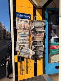 Newspapers are displayed outside a shop.