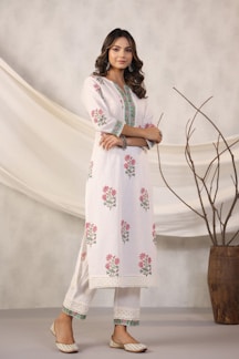 Woman models a white floral kurta pajama.