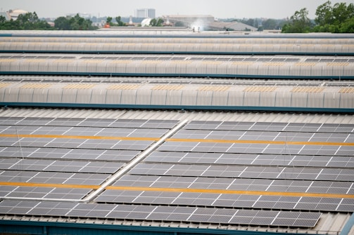 Solar panels cover a large industrial building's roof.
