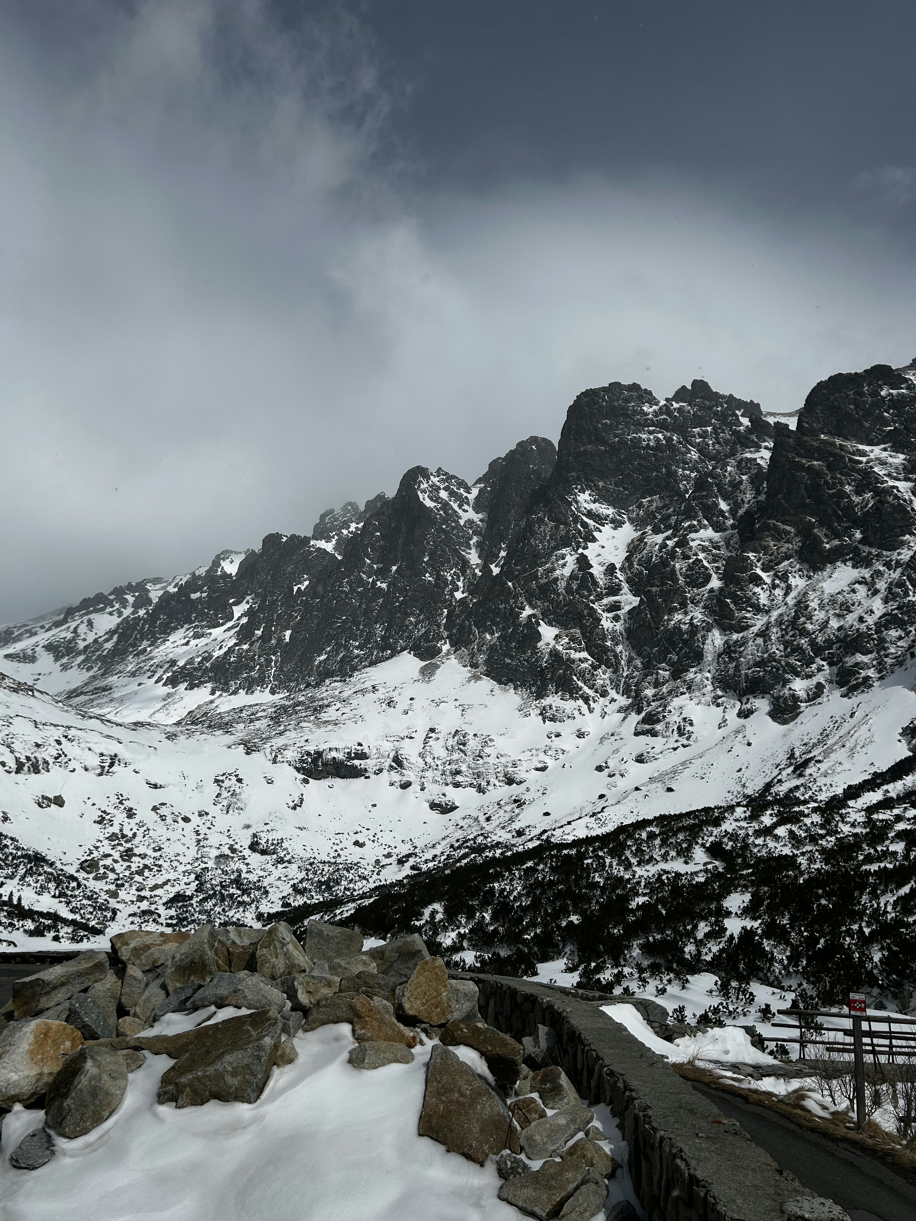 Snow-covered mountains under a cloudy sky.