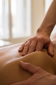 Massage therapist giving a back massage.
