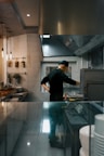 A chef works in a restaurant kitchen.
