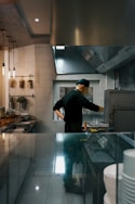 A chef works in a restaurant kitchen.
