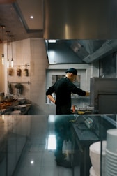 A chef works in a restaurant kitchen.
