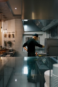 A chef works in a restaurant kitchen.