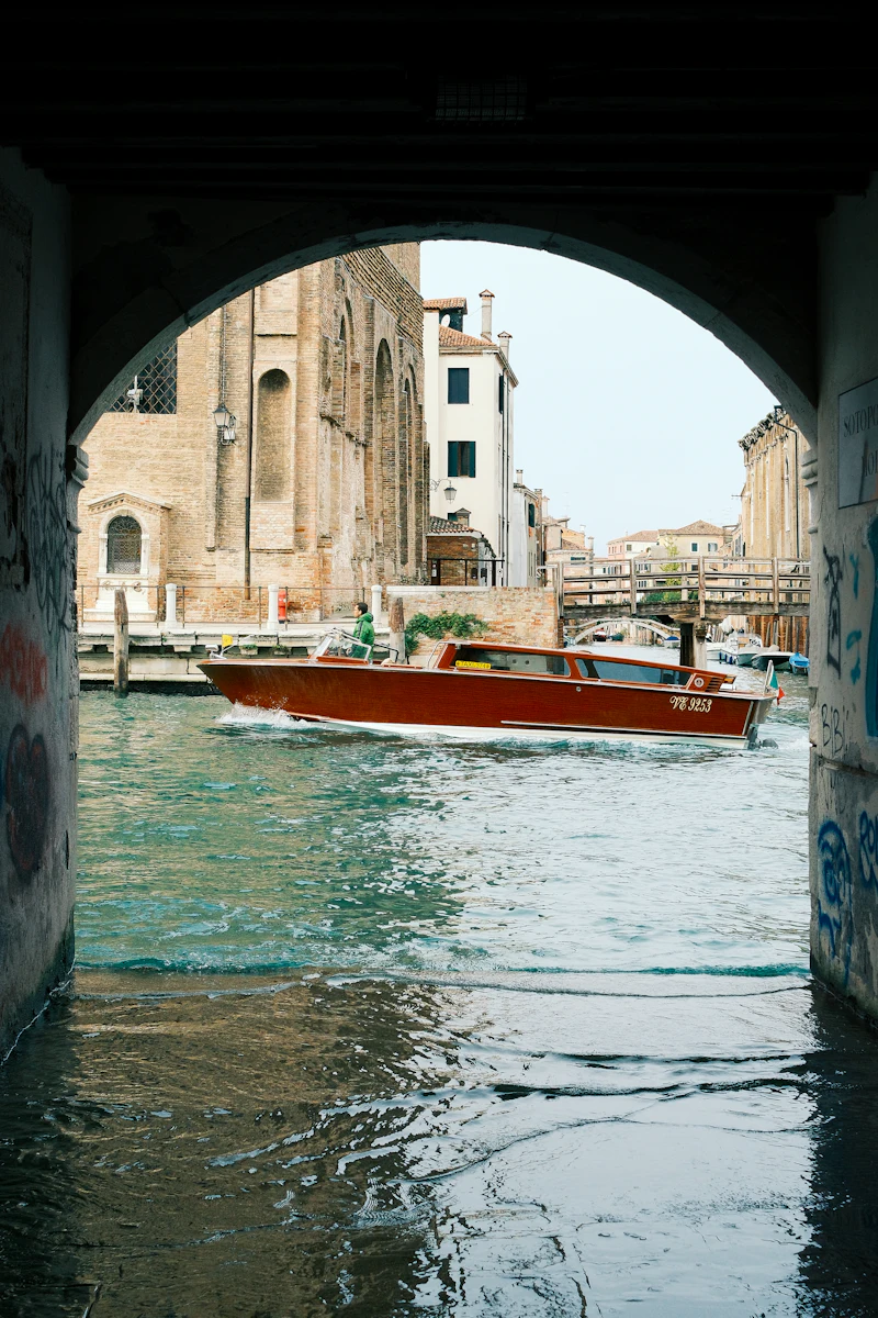 A classic Venetian water taxi cruising a canal