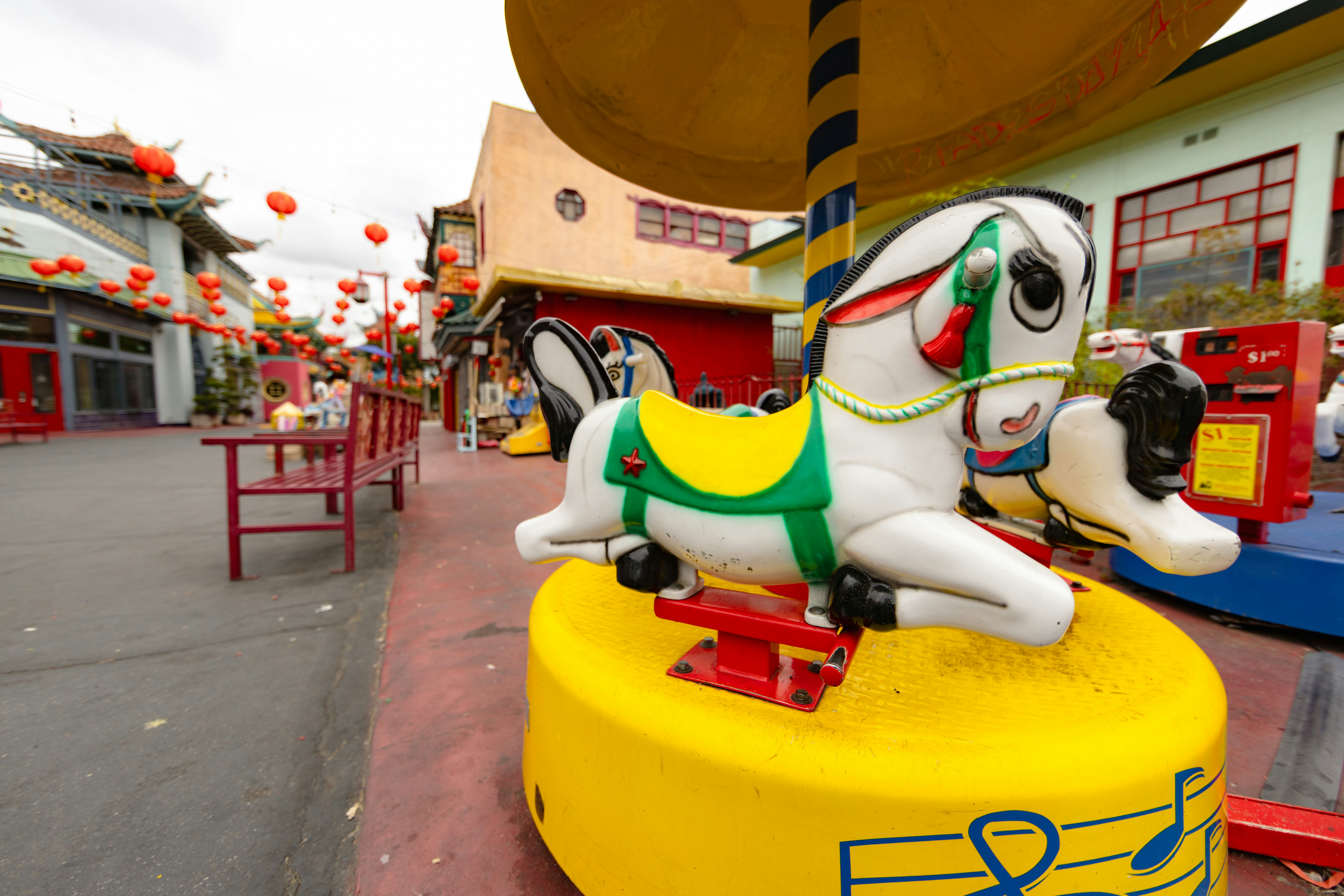 A child's ride stands in the vibrant square.