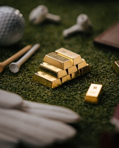 Gold bars sit on golf course turf.