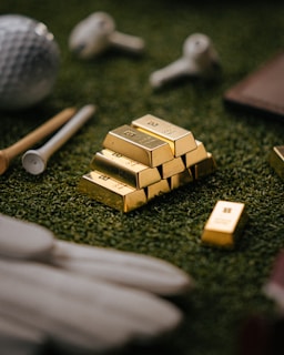 Gold bars sit on golf course turf.