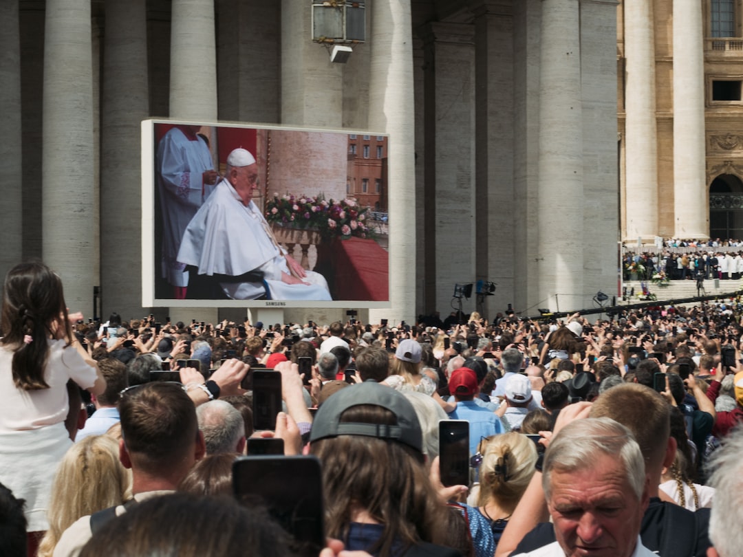 People watch pope francis on a large screen., Pope Francis appearing for the last time on the St. Peter