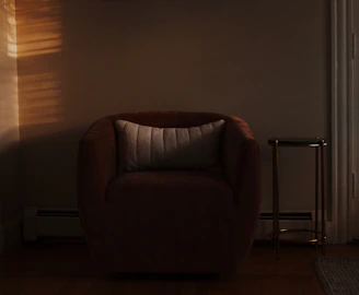 A comfortable chair in soft, warm light.