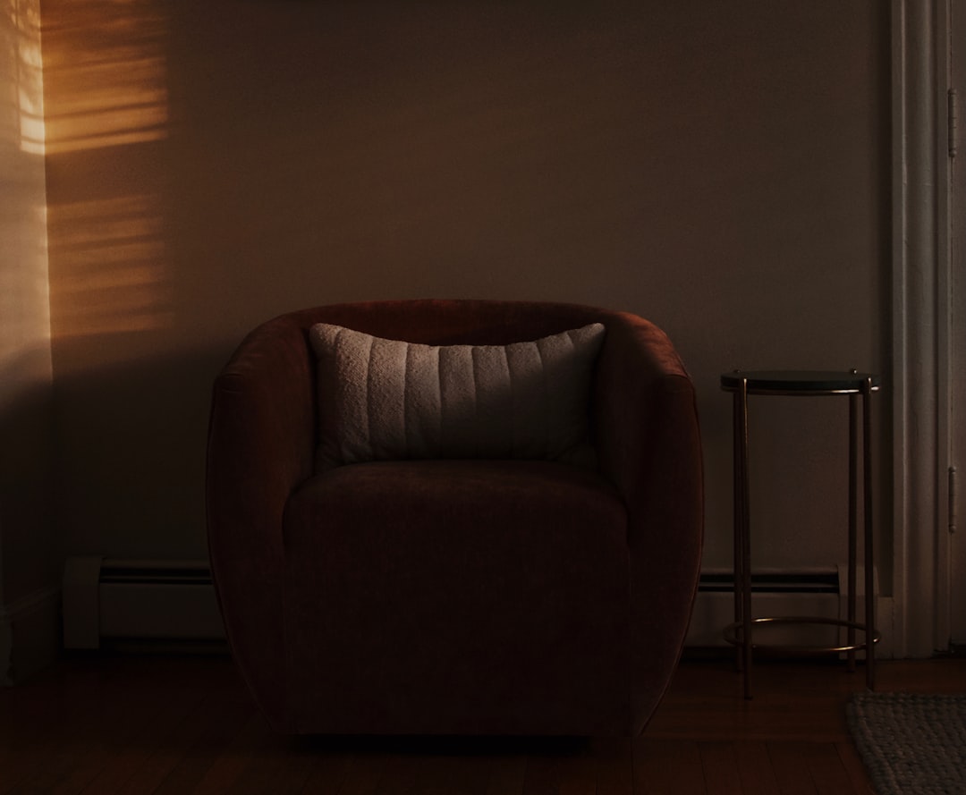 A comfortable chair in soft, warm light., Round chair with window light.