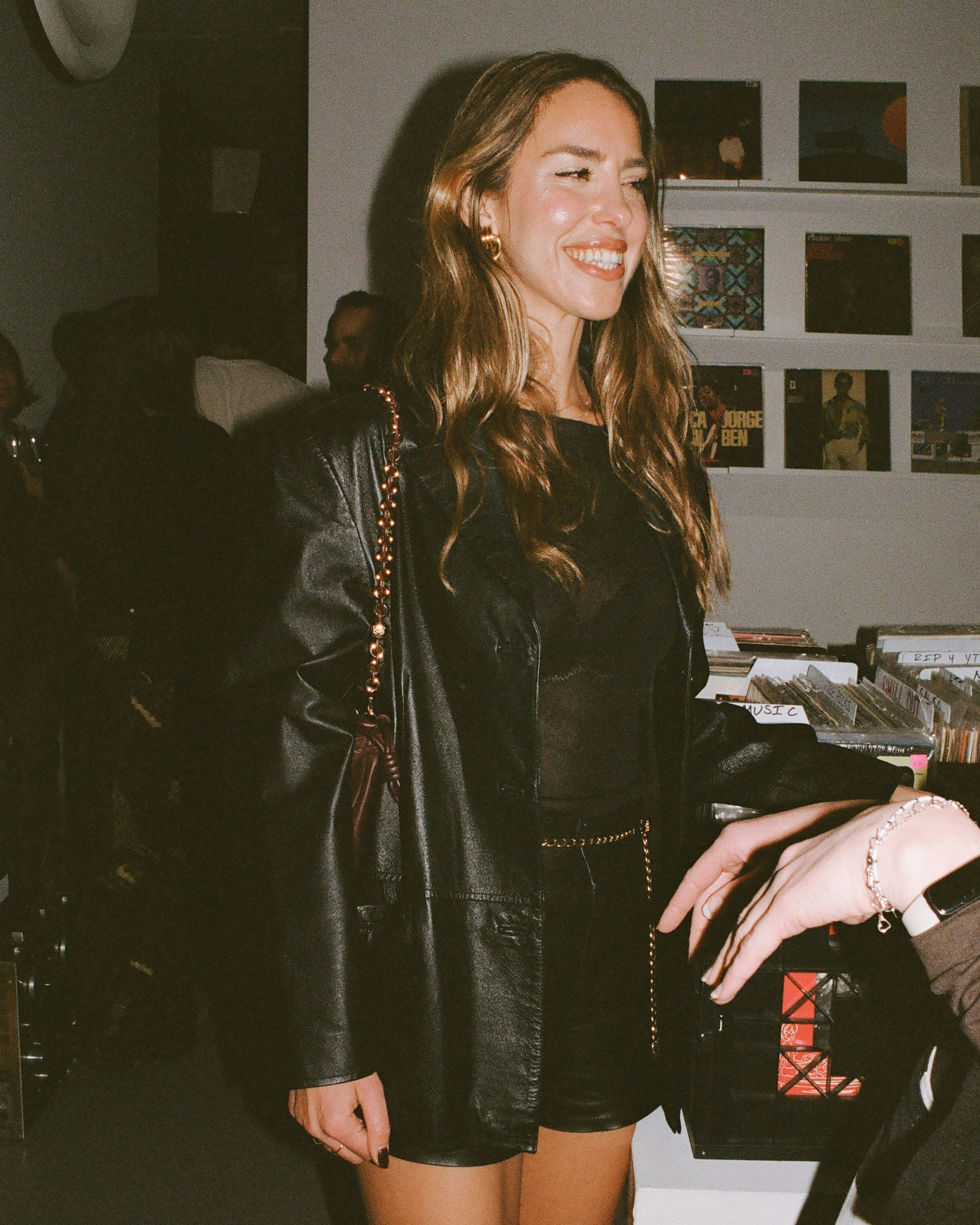 A woman smiles while posing at an event