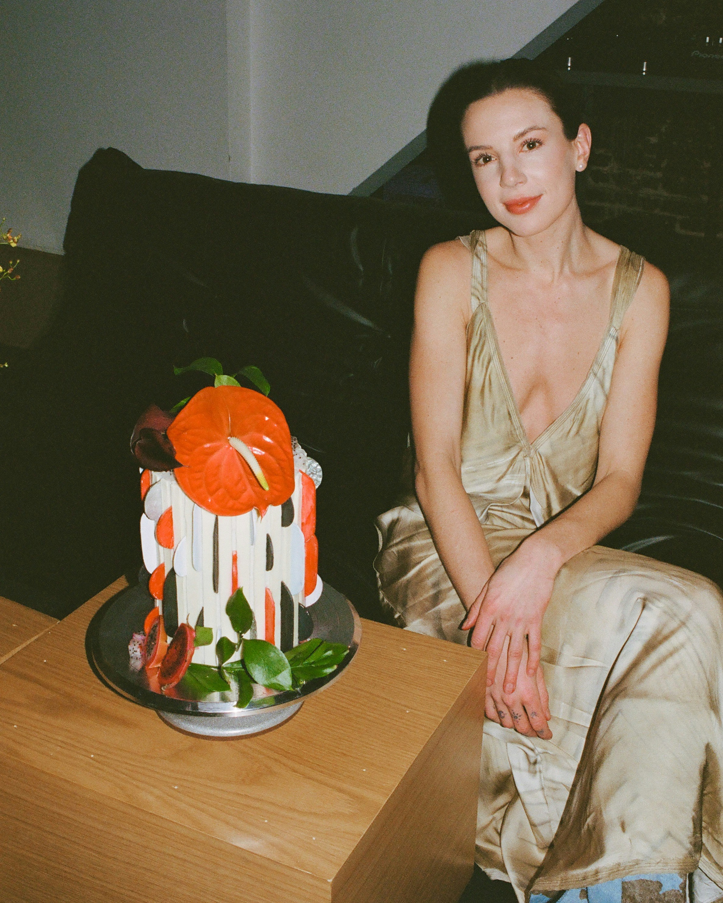 Woman poses with a unique decorated cake