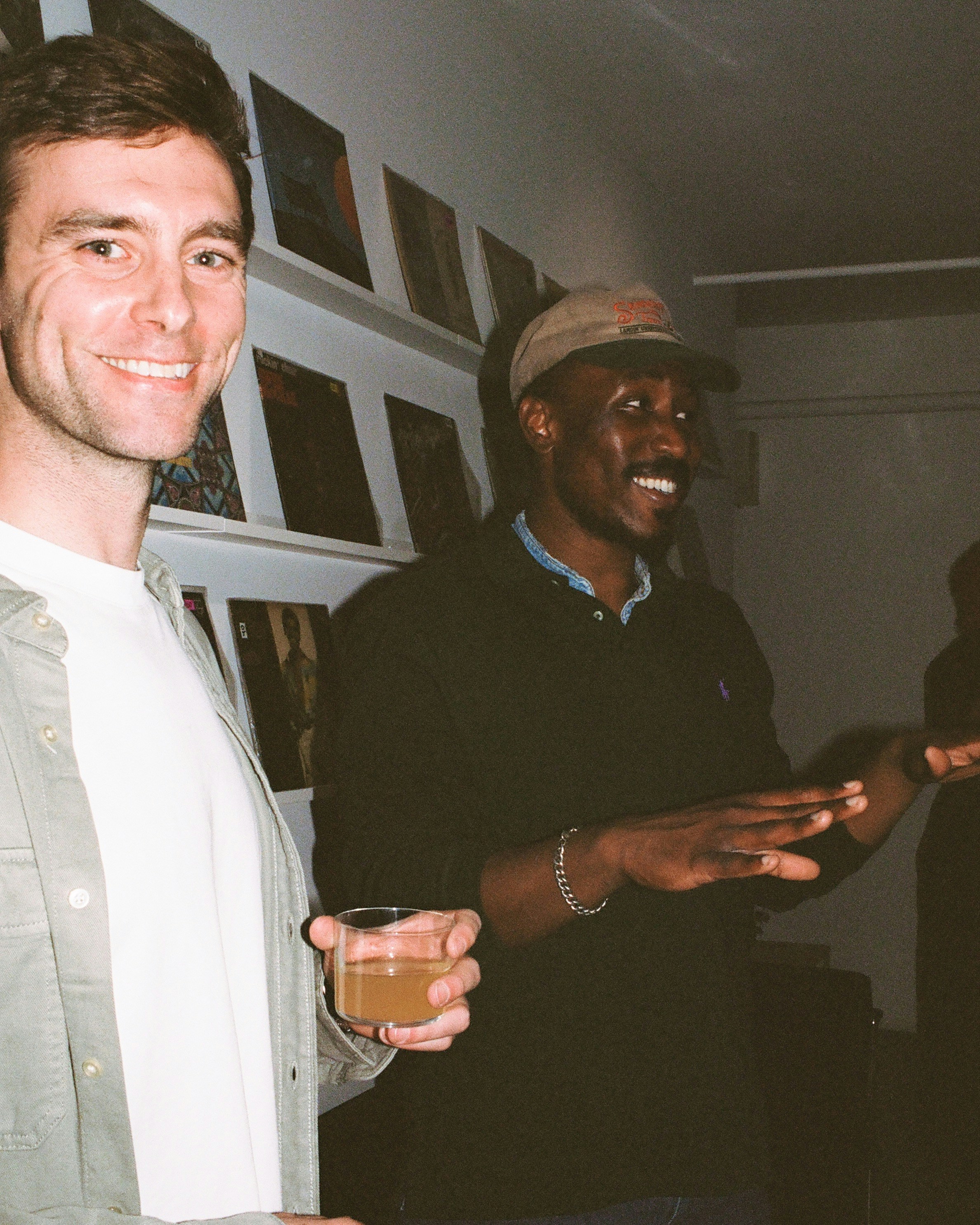 Two men smile and chat at an event