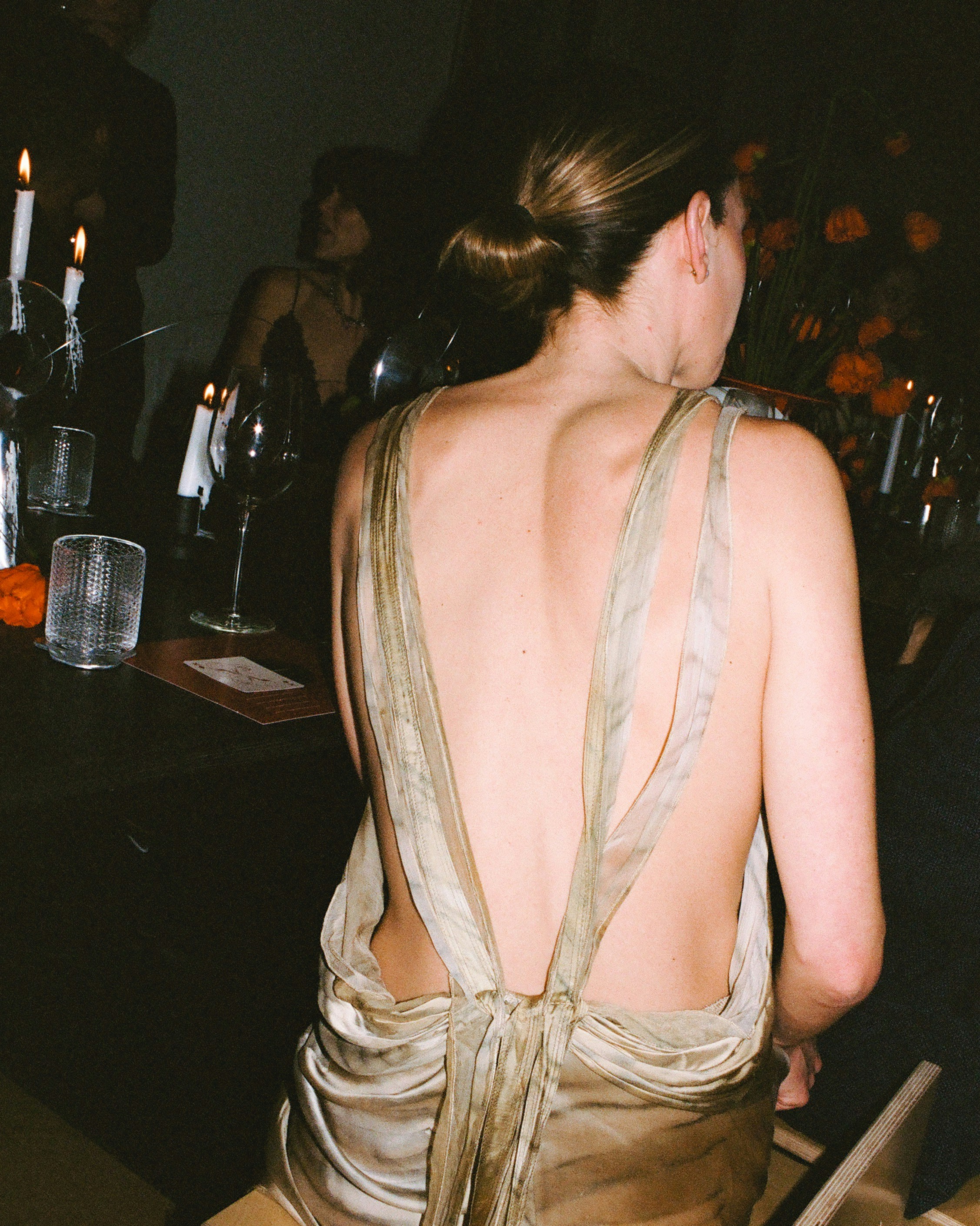 Woman in backless dress at a dinner party