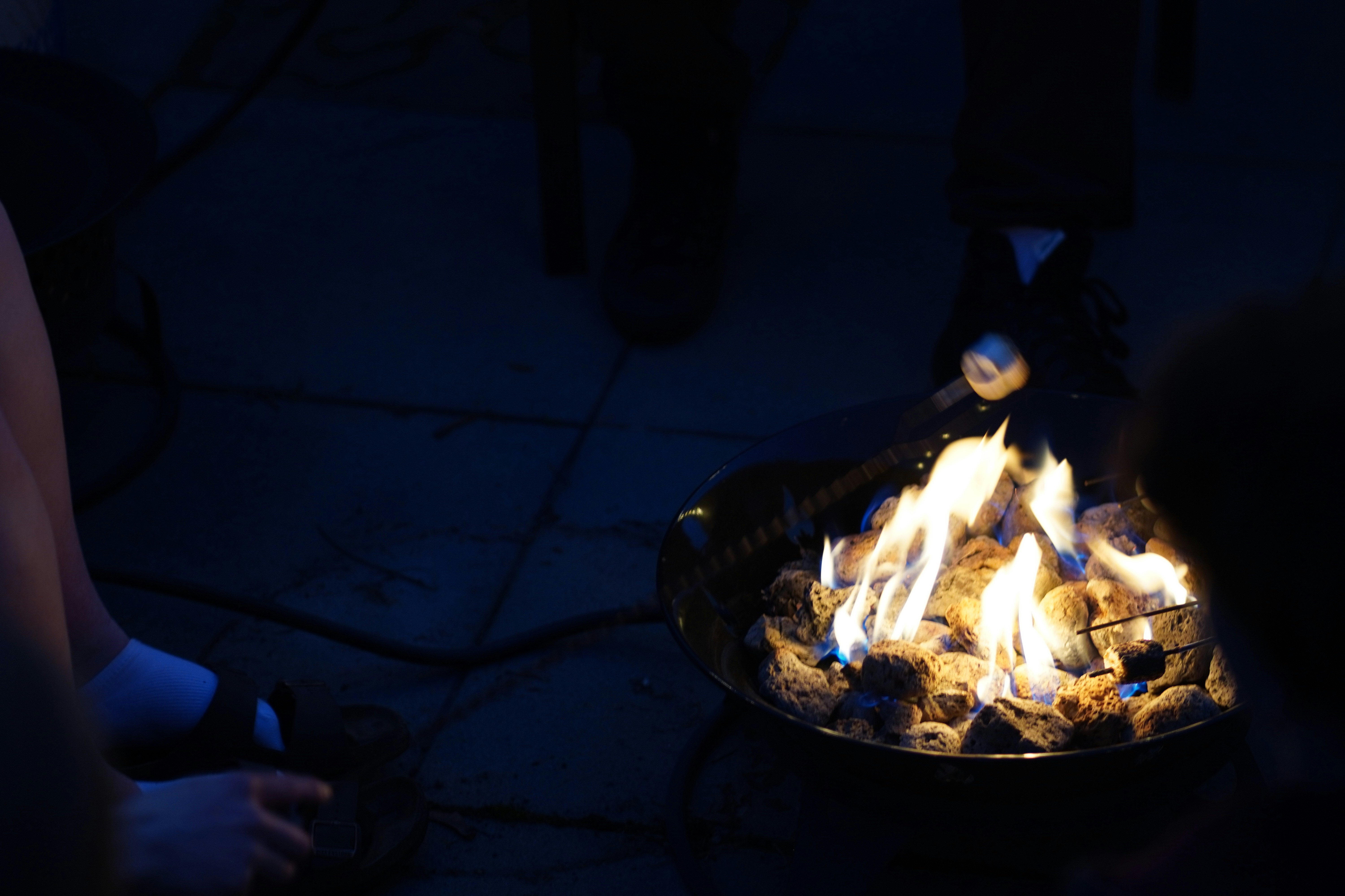 A bonfire burns bright in the night.