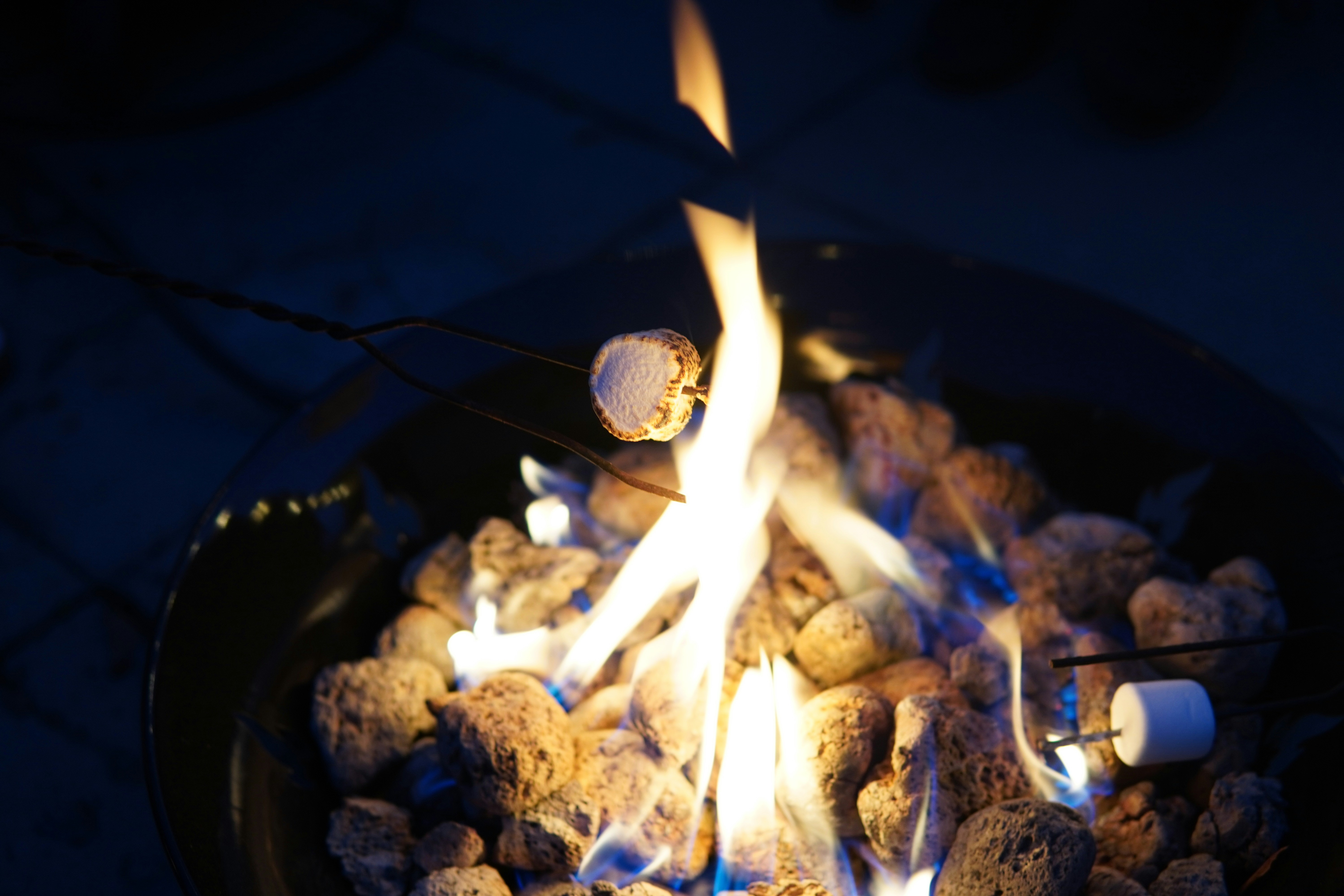 Marshmallows roasting over a fire.