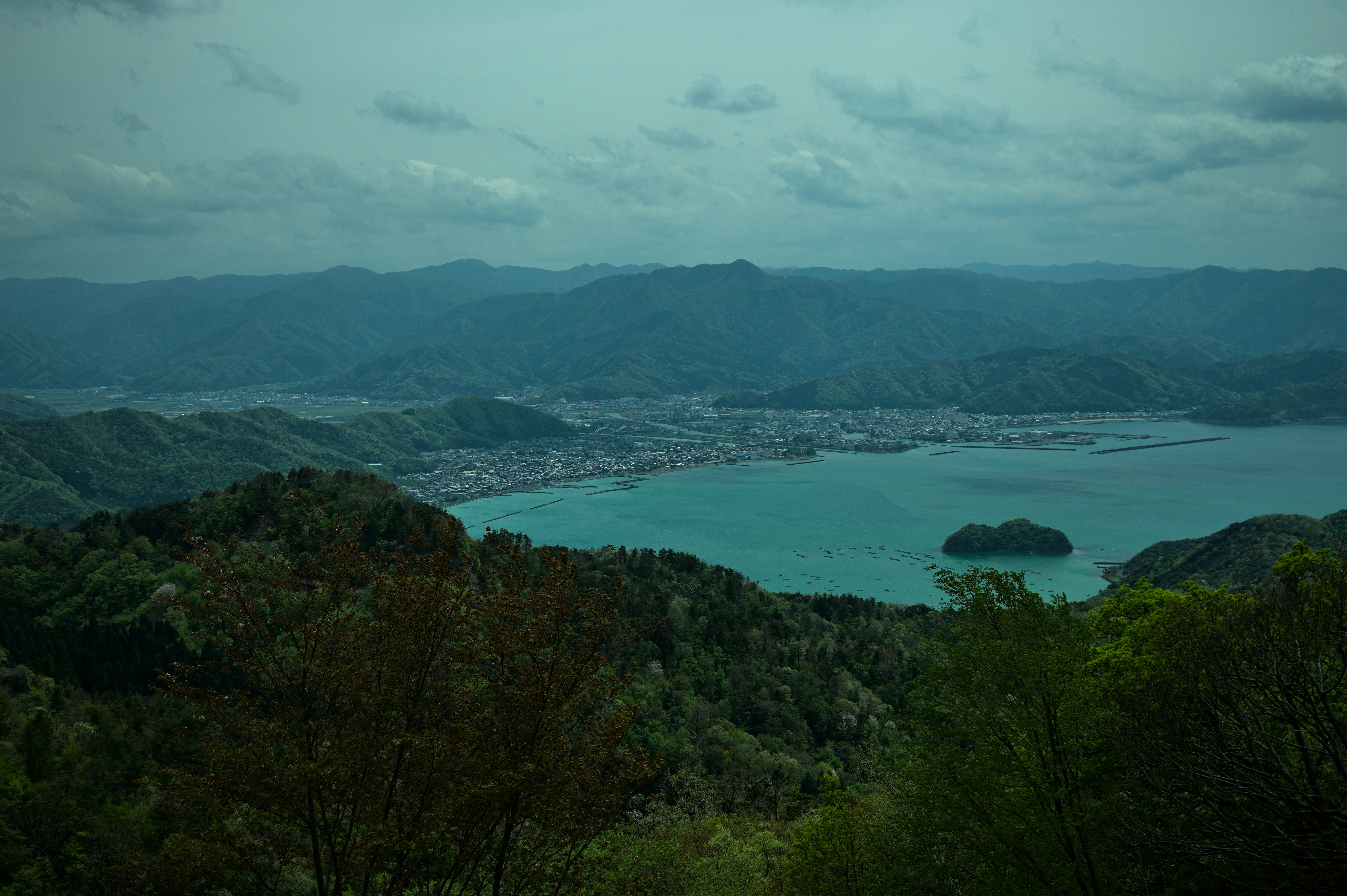 Mountains and a bay are viewed from a high perspective.