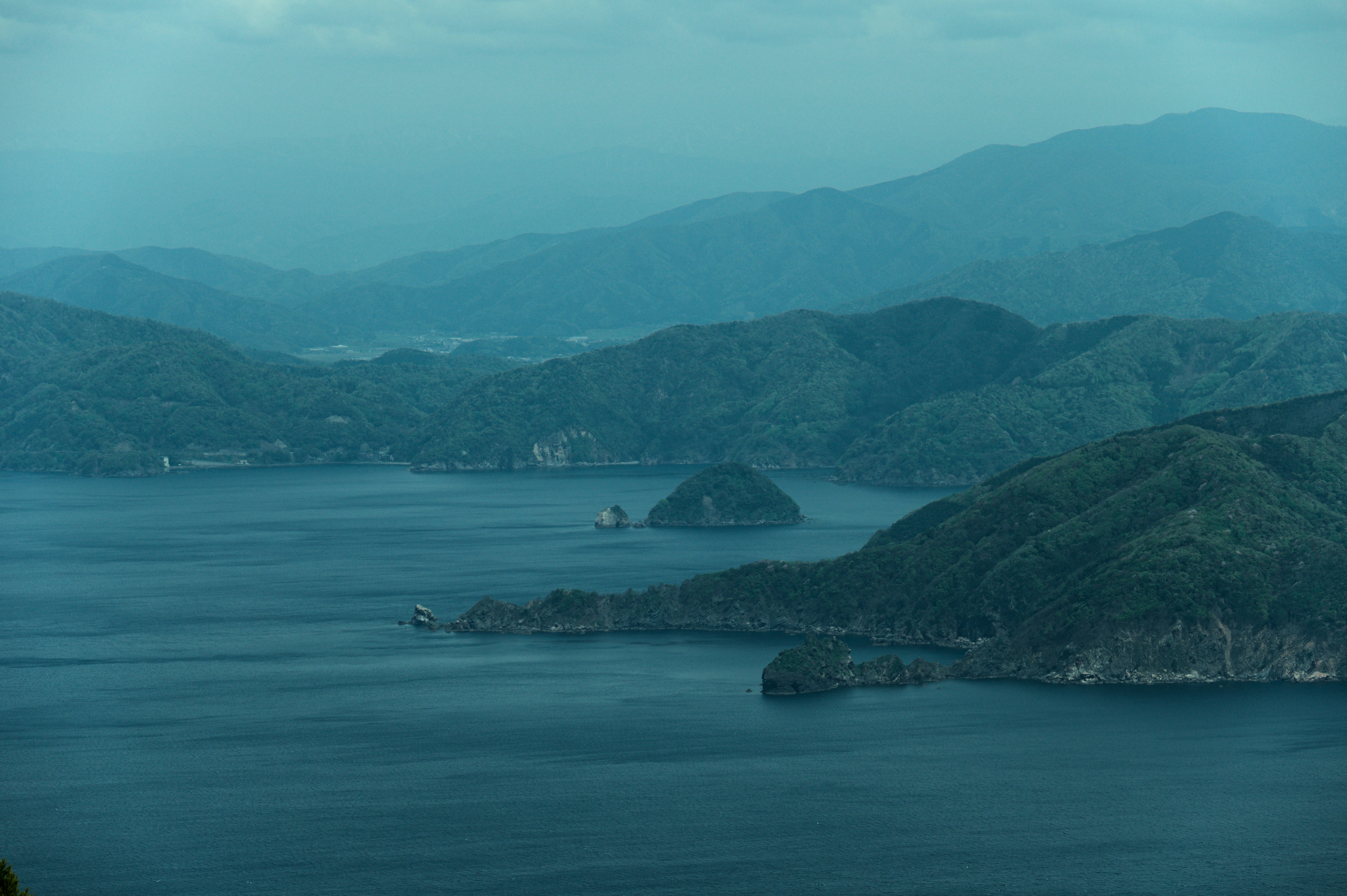 Mountains surround a calm body of water.