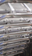 Metal chairs are stacked in a close-up view