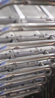 Metal chairs are stacked in a close-up view