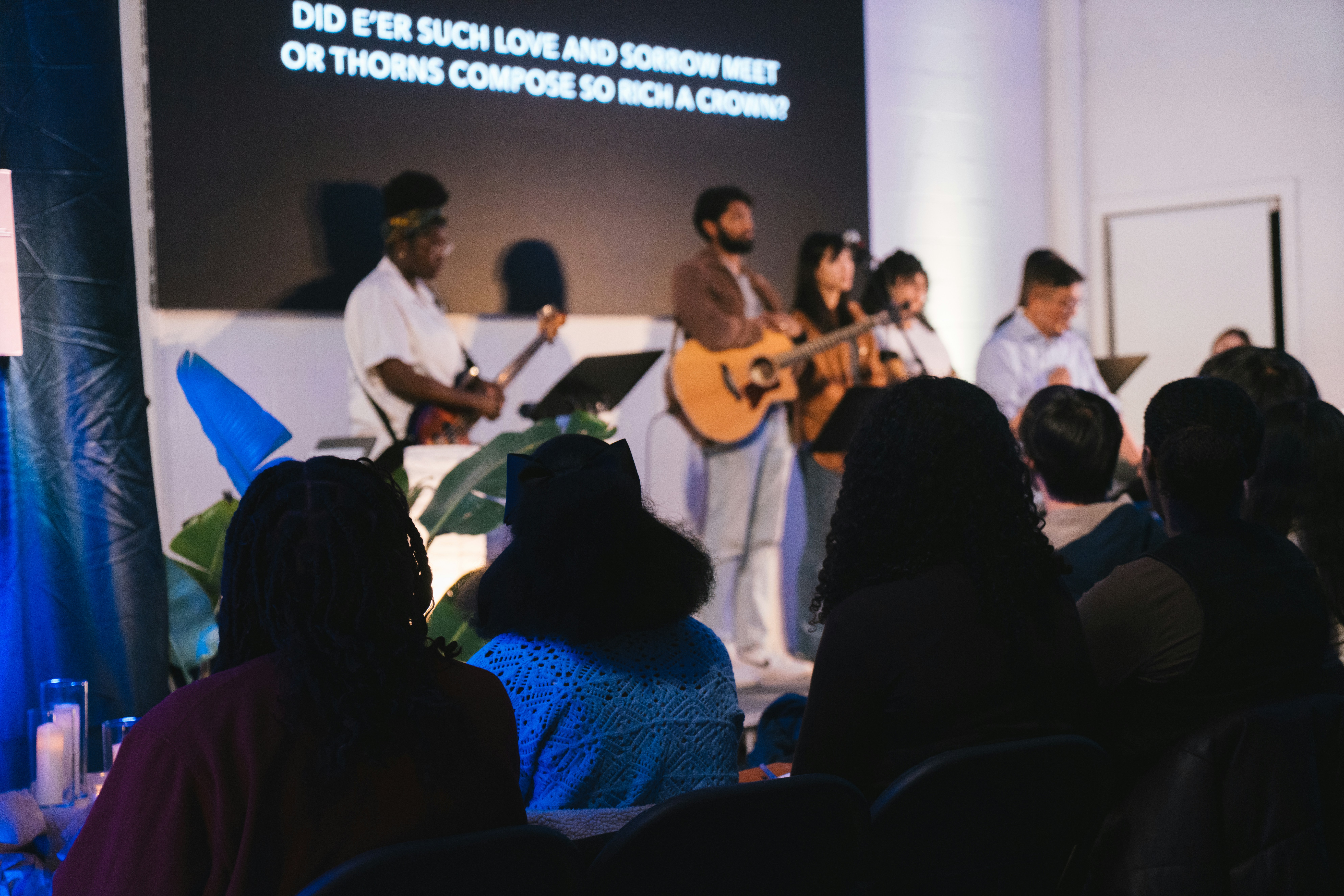 A band performs music on stage for an audience.
