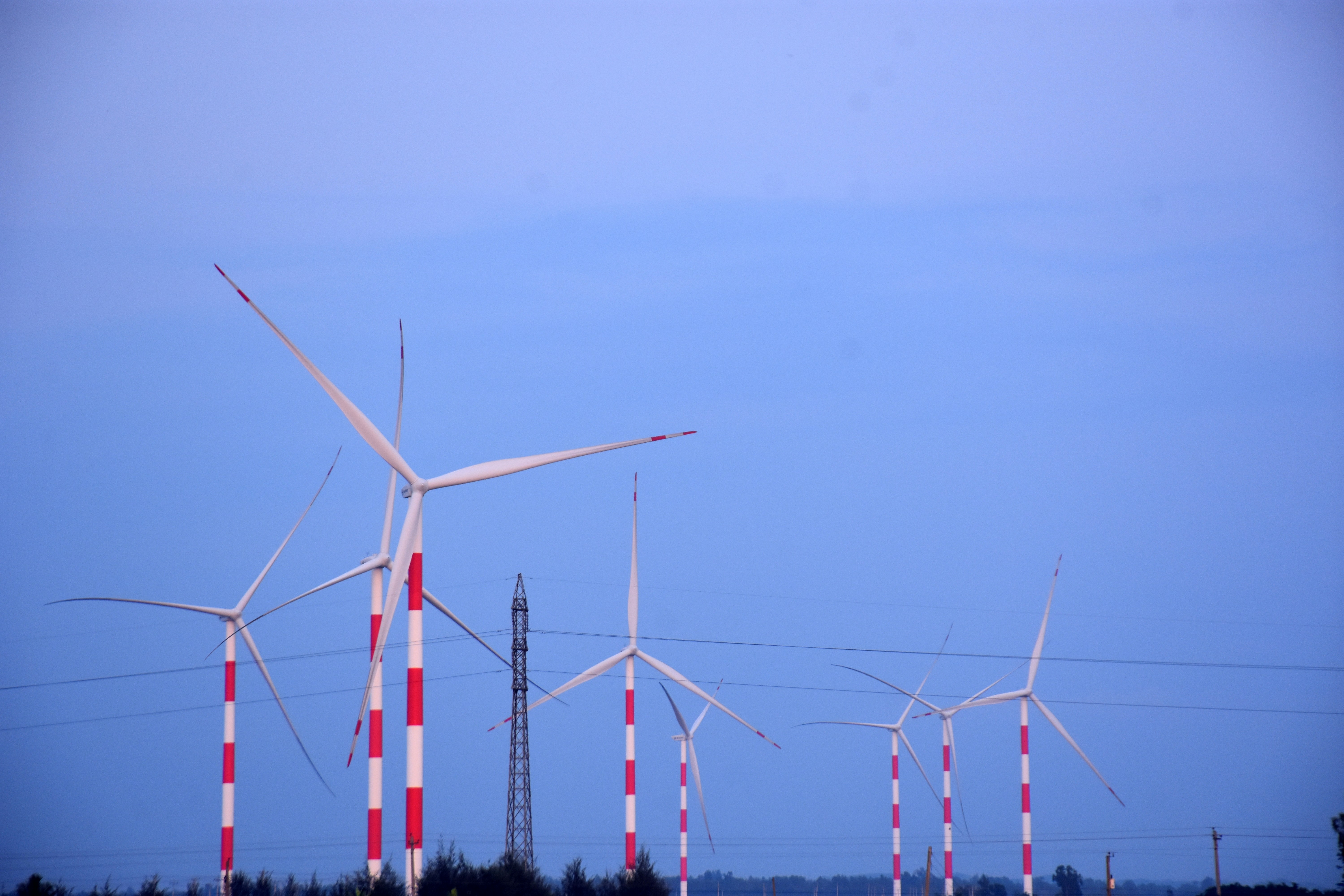Wind turbines generate clean energy on a clear day.