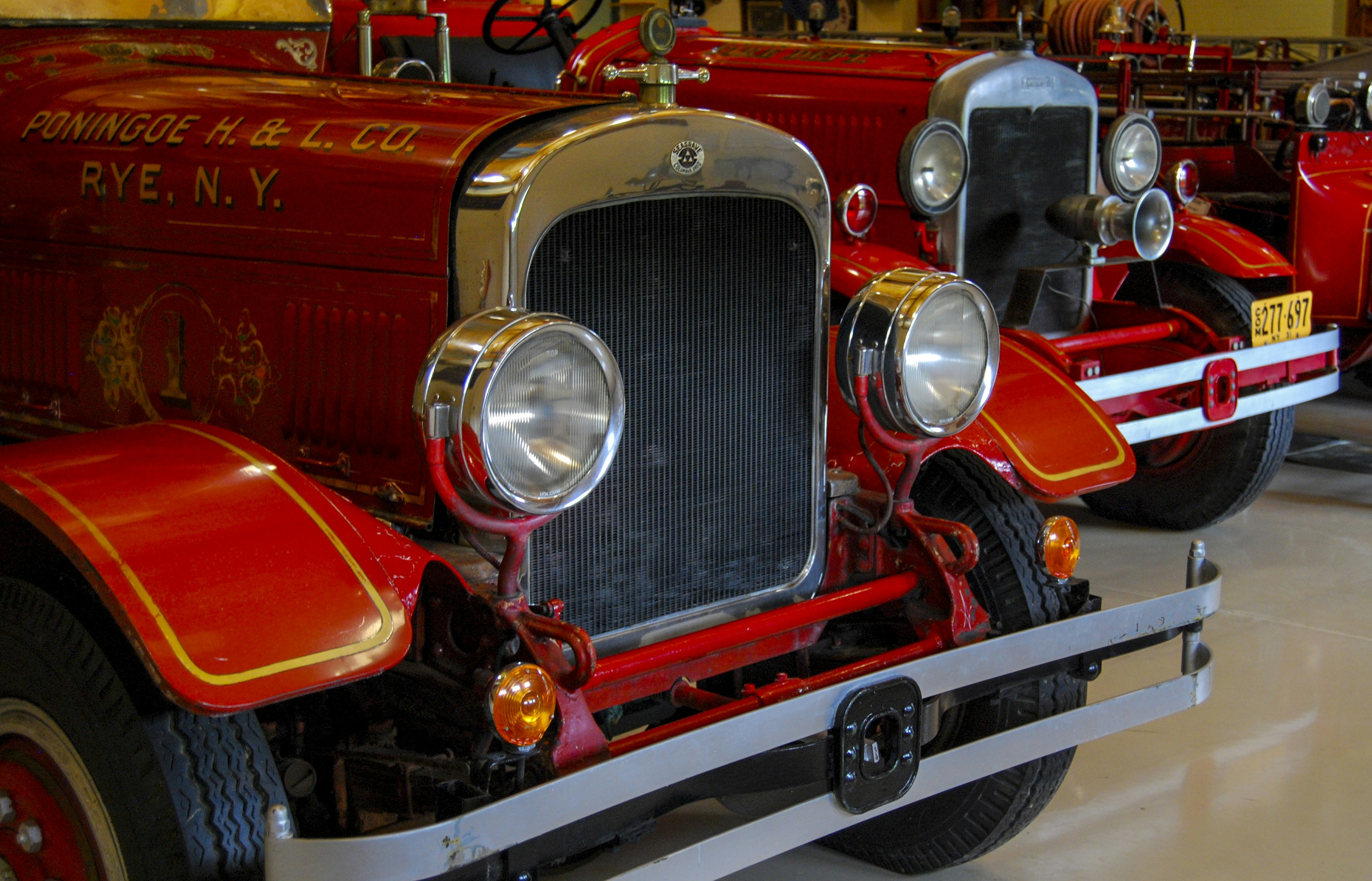 Antique fire trucks are on display.