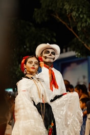 Couple dressed in día de los muertos attire.