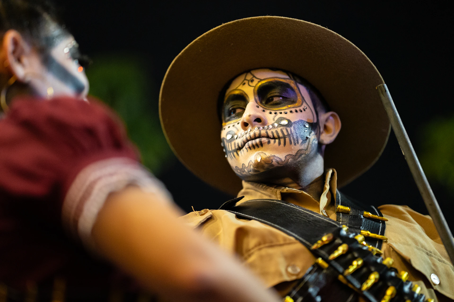 A man in skull makeup celebrates the day of the dead.