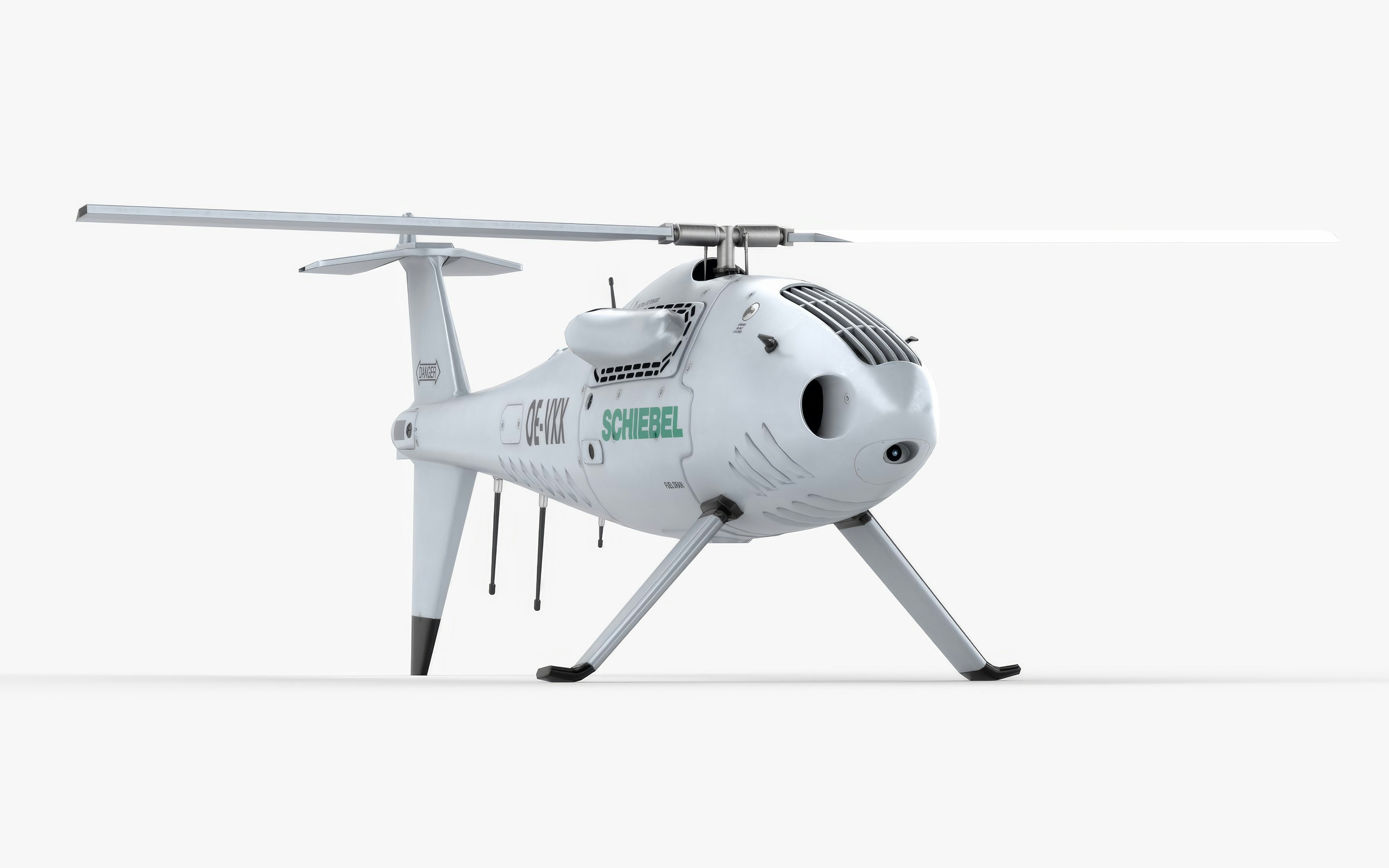 Here's a caption for the image: a white drone helicopter is seen.