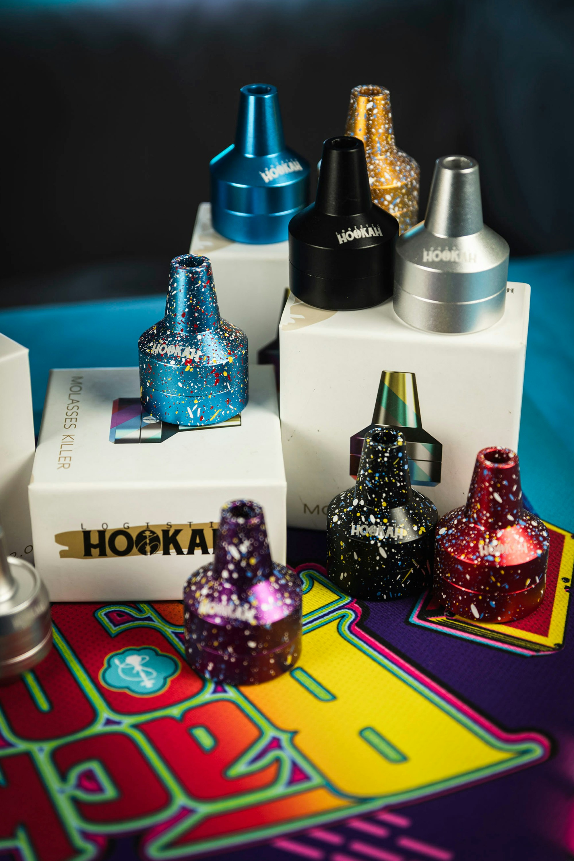 Colorful hookah bowls are arranged on boxes.