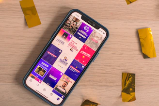 A phone displays a colorful social media feed