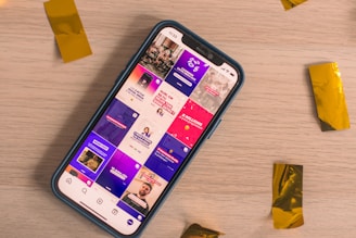 A phone displays a colorful social media feed.