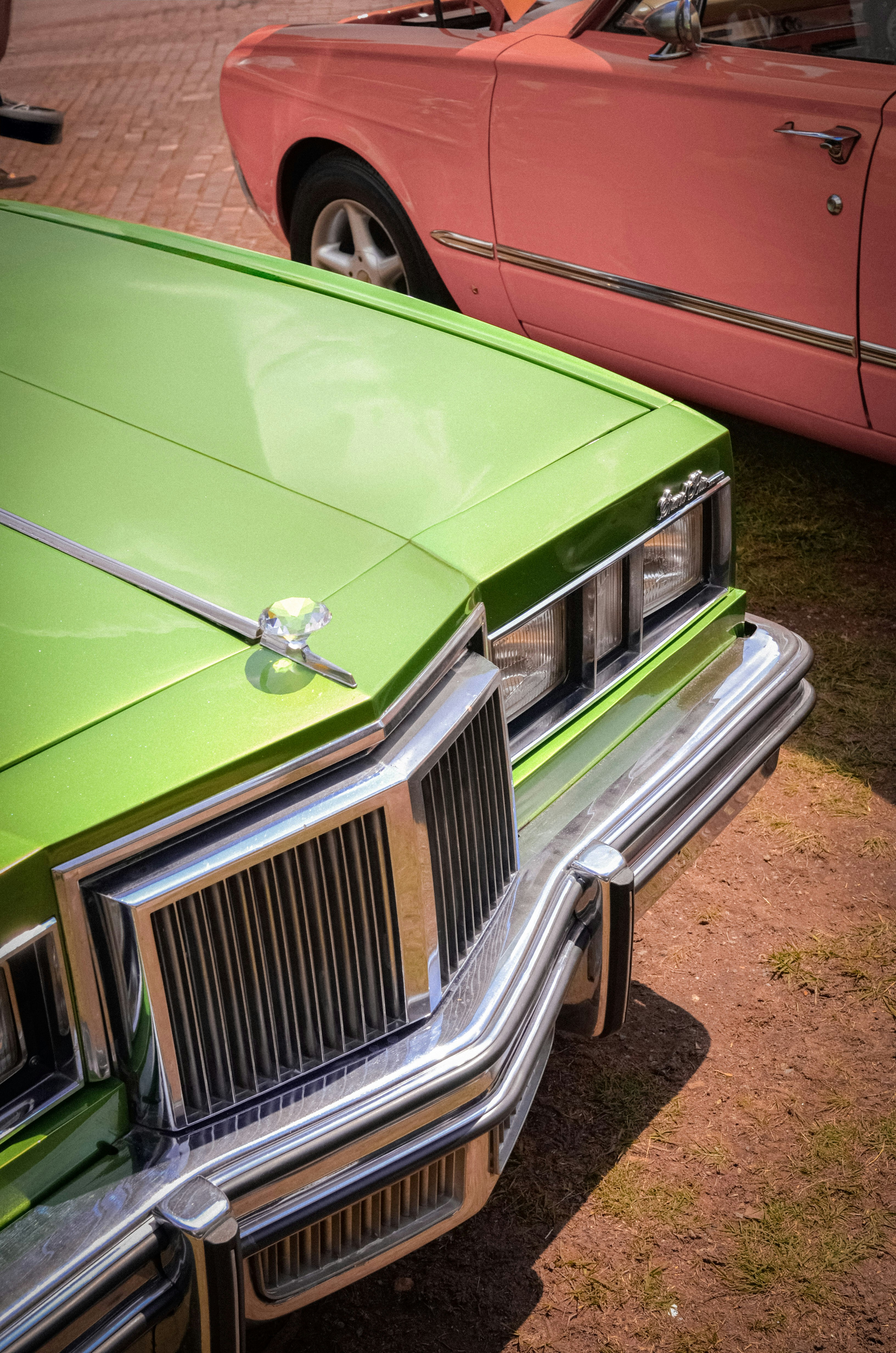 Classic cars in vibrant green and pink.
