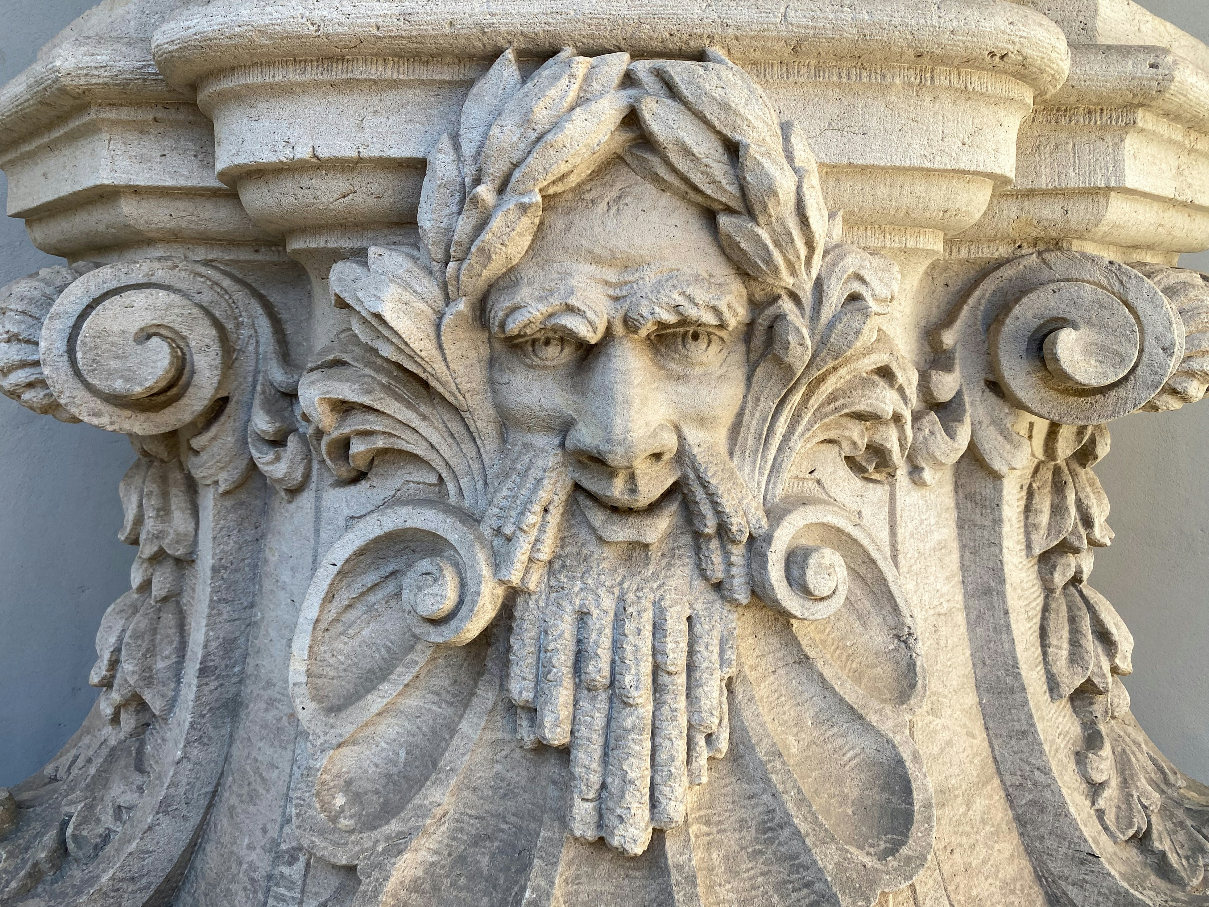 A stone sculpture of a bearded face.