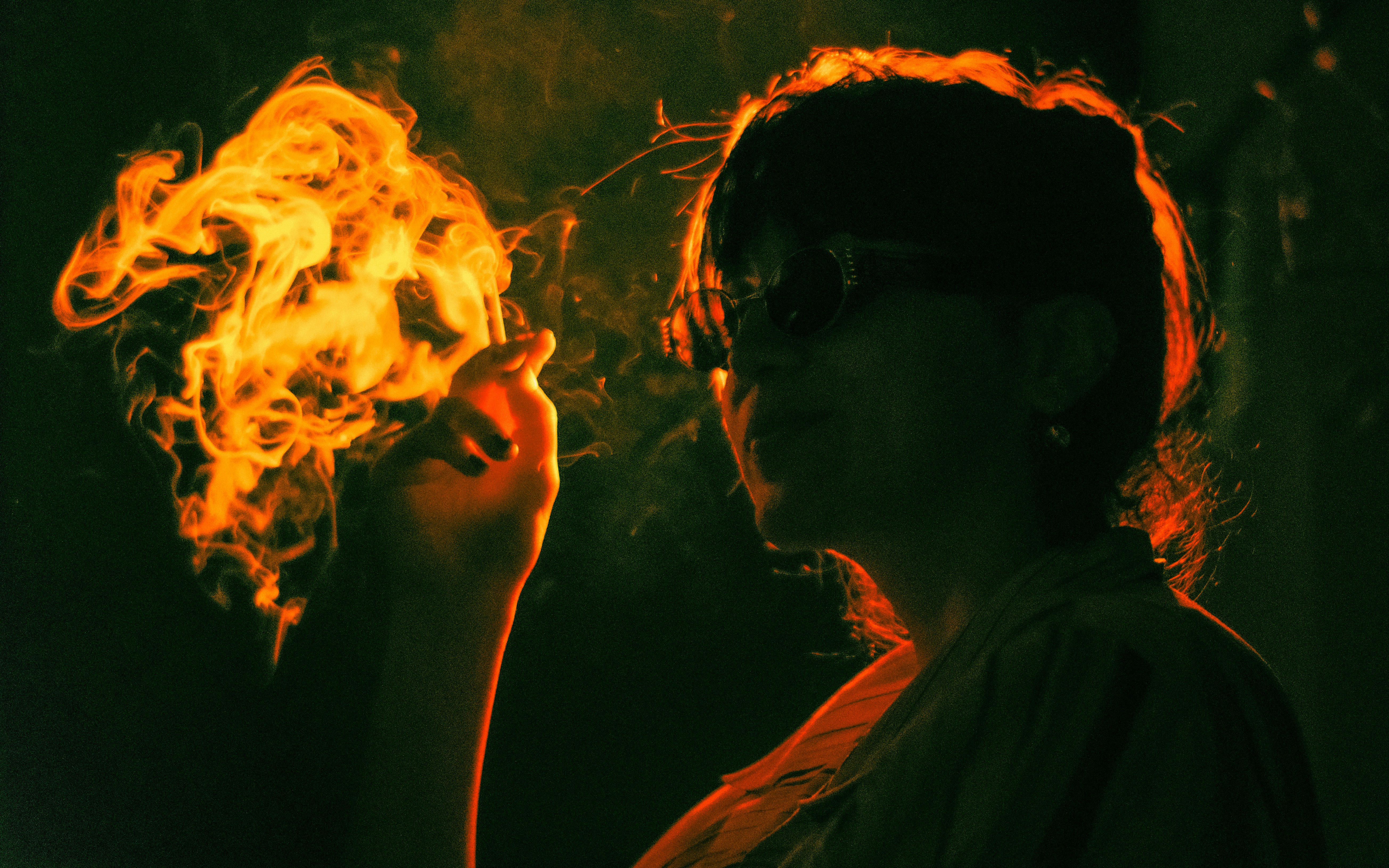 A person holds fire in their hand.