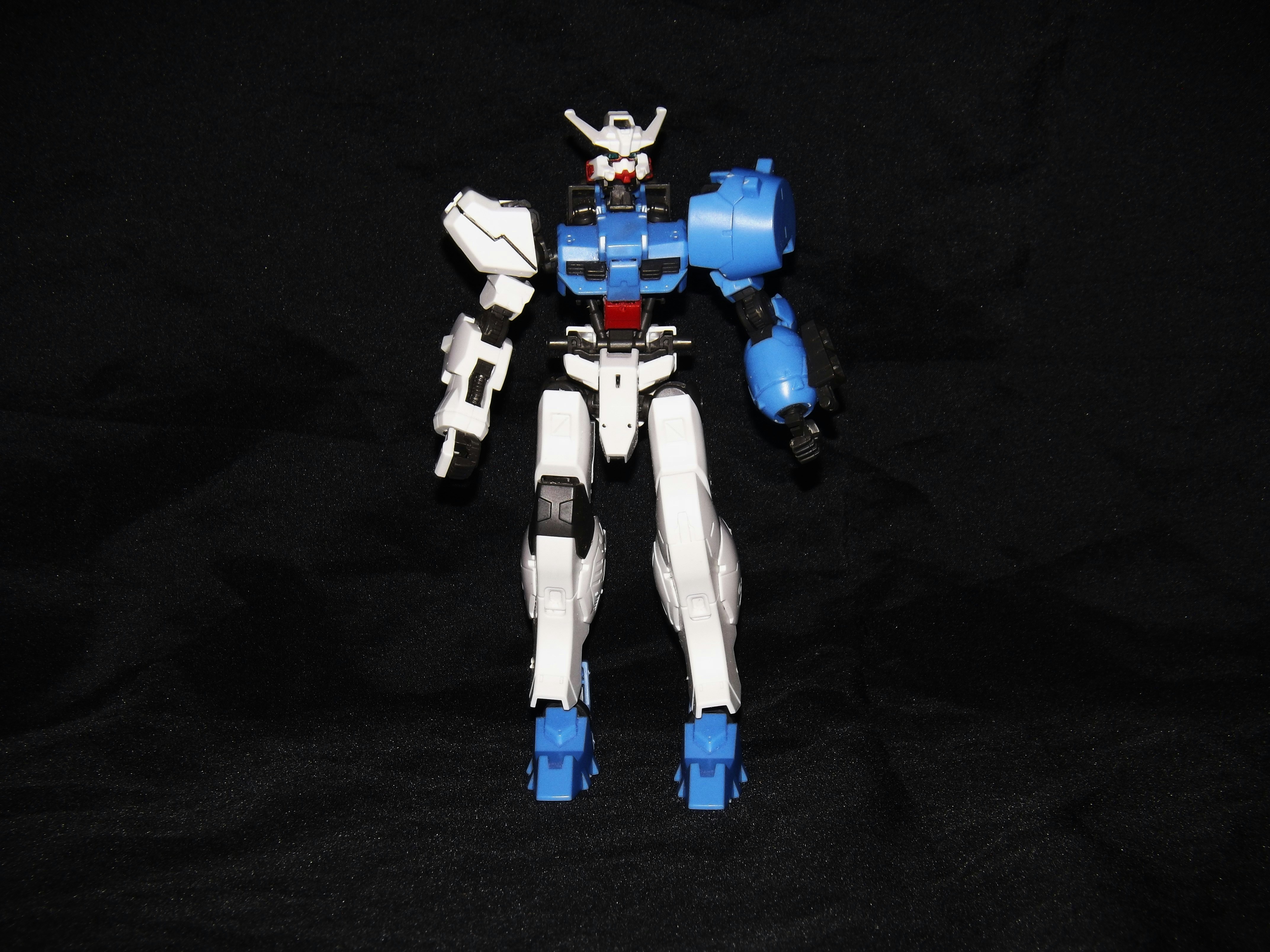 A gundam model kit is partially assembled.